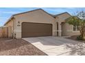 Close up of this single-story home featuring desert landscaping and a two-car garage at 18621 W Hackamore Dr, Surprise, AZ 85387