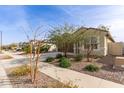 A neighborhood street view of a single-story home with desert landscaping at 18621 W Hackamore Dr, Surprise, AZ 85387