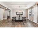 Elegant dining room with wood-look tile floors and a stylish light fixture at 19797 W Lincoln St, Buckeye, AZ 85326