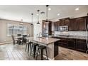 Spacious kitchen features a large center island with seating and modern stainless steel appliances at 19797 W Lincoln St, Buckeye, AZ 85326