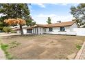 Charming single-story home with a brick exterior, complemented by an attached garage and green front yard at 2032 W Eugie Ave, Phoenix, AZ 85029