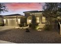 Beautifully landscaped home exterior showcasing a manicured yard, charming facade, and a two-car garage at 20594 S 194Th Pl, Queen Creek, AZ 85142