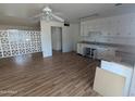 Kitchen and living area featuring wood floors, white cabinets and decorative divider at 3452 E Evans Dr, Phoenix, AZ 85032