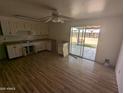 Kitchen and dining area with wood-look floors and sliding glass doors to the backyard at 3452 E Evans Dr, Phoenix, AZ 85032