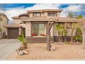 Front exterior of home with a landscaped yard, a tile roof, and large windows at 3588 S 257Th Ave, Buckeye, AZ 85326