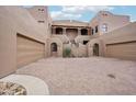 Charming home featuring a courtyard with dual garage doors and gated entrances at 36601 N Mule Train Rd # C38, Carefree, AZ 85377