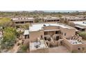 Spacious stucco home with patio seating and desert landscaping in a peaceful community setting at 36601 N Mule Train Rd # C38, Carefree, AZ 85377