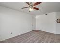 A simple empty living room featuring neutral carpet and a white wall at 3830 E Lakewood E Pkwy # 2009, Phoenix, AZ 85048