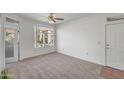 Inviting living room featuring neutral carpet, ample natural light, and access to the balcony at 3830 E Lakewood E Pkwy # 2009, Phoenix, AZ 85048