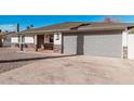 Charming home with a desert rock yard, stone accents, two car garage, and well-maintained driveway at 4720 N 63Rd Ave, Phoenix, AZ 85033