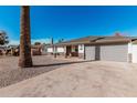 Charming home with a desert rock yard, stone accents, two car garage, and covered entry at 4720 N 63Rd Ave, Phoenix, AZ 85033