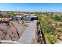 Aerial view of estate home featuring tile roof, solar panels, desert landscaping and long driveway at 5237 E Montgomery E Rd, Cave Creek, AZ 85331