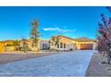 Well-maintained home with desert landscaping, a tile roof, and a spacious paver driveway at 5237 E Montgomery E Rd, Cave Creek, AZ 85331