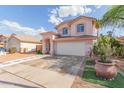 Inviting two-story home showcasing a well-maintained front yard, desert landscaping, and a spacious driveway at 6219 W Navajo Dr, Glendale, AZ 85302