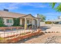 Charming single-story home with lush greenery, a decorative front fence, and a welcoming entrance at 901 E Hearn Rd, Phoenix, AZ 85022