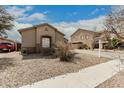 Tan home featuring a window, a red truck in the driveway, and a well-kept yard at 9325 W Elwood St, Tolleson, AZ 85353