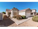 Inviting home exterior with well-manicured landscaping, a tiled roof, and a welcoming front entrance at 977 E Saratoga St, Gilbert, AZ 85296