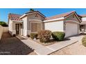 The exterior of this home features a red tile roof, manicured landscaping, and a front entrance walkway at 977 E Saratoga St, Gilbert, AZ 85296