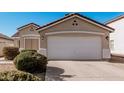 Close-up of a home's garage with a clean concrete driveway, featuring a red-tiled roof and manicured shrubs at 977 E Saratoga St, Gilbert, AZ 85296