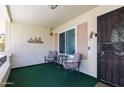 Inviting covered front porch with seating area and decorative desert-themed accents at 10106 W Highwood Ln, Sun City, AZ 85373