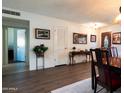 Hallway view with wood flooring and decorative console table at 10106 W Highwood Ln, Sun City, AZ 85373