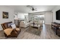 Bright and airy living room with tile floors, a comfortable sectional sofa, and backyard pool view at 10547 E Relativity Ave, Mesa, AZ 85212