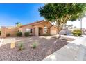 Inviting single-story home featuring desert landscaping, a cozy front entrance, and an attached two-car garage at 1077 E Loma Vista St, Gilbert, AZ 85295