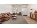 Bright living room featuring neutral carpeting, and stylish furnishings creating a welcoming atmosphere at 1077 E Loma Vista St, Gilbert, AZ 85295