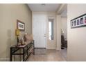 Welcoming entryway featuring tile flooring, neutral paint, and a console table at 10817 W Swayback Pass, Peoria, AZ 85383