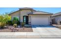 Charming single-story home featuring a well-manicured front yard and an attached two-car garage at 10817 W Swayback Pass, Peoria, AZ 85383