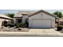 Charming single story home with a neutral color palette, two car garage, and desert landscaping at 11029 W Oraibi Dr, Peoria, AZ 85373