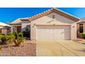 Charming single-story home featuring a two-car garage and desert landscaping for low maintenance appeal at 11029 W Oraibi Dr, Peoria, AZ 85373