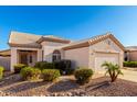 Inviting single-story home with desert landscaping, a two-car garage and a beautiful tile roof at 11029 W Oraibi Dr, Peoria, AZ 85373