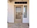 Front entrance with glass door, security system, and a sidelight window for added natural light at 11029 W Oraibi Dr, Peoria, AZ 85373