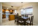 Bright kitchen with oak cabinets and dining area filled with natural light from large window at 12222 N Paradise Village S Pkwy # 405, Phoenix, AZ 85032