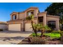 Charming two-story home featuring a two-car garage and mature palm trees in the front yard at 13025 W Gelding Dr, El Mirage, AZ 85335