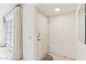 Bright entryway featuring a white door, tile flooring, neutral walls, and a window for natural light at 13354 W Stonebrook Dr, Sun City West, AZ 85375