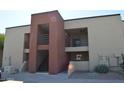 Condo building with private patios, desert landscaping, and stairway access at 1340 N Recker Rd # 254, Mesa, AZ 85205