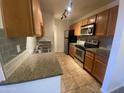 Updated kitchen featuring stainless steel appliances, wooden cabinets, and neutral countertops at 200 E Southern Ave # 348, Tempe, AZ 85282