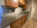 Neutral backsplash and stainless steel sink highlight this efficient kitchen area at 200 E Southern Ave # 348, Tempe, AZ 85282