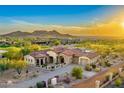 Beautiful desert home featuring a red tile roof, stone accents, spacious driveway, and desert landscaping at 2430 S Geronimo Head Trl, Gold Canyon, AZ 85118