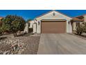 Single Gathering home with two car garage and desert landscaping at 27044 W Escuda Dr, Buckeye, AZ 85396