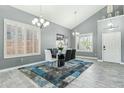 Dining room features modern chandelier, plantation shutters, and stylish decor at 2755 E Cowboy Cove Trl, San Tan Valley, AZ 85143