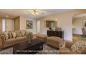 Comfortable living room featuring an area rug, ceiling fan, and plush seating at 2801 N Dakota St, Chandler, AZ 85225