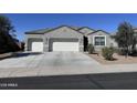 Charming single-story home featuring a gray stucco exterior, a two-car garage, and low maintenance landscaping at 2994 N 305Th Dr, Buckeye, AZ 85396