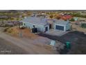 Gorgeous view of the house featuring gray paint, rock, and a spacious driveway at 3002 W Josiah Trl, Queen Creek, AZ 85144