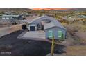 Aerial shot showcasing home with desert landscaping and a large, paved driveway area at 3002 W Josiah Trl, Queen Creek, AZ 85144