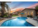 Backyard oasis with a refreshing pool, lush lawn, and comfortable seating for outdoor relaxation at 4411 E Spur Dr, Cave Creek, AZ 85331