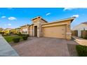 Inviting single-story home with stone veneer accents, desert landscaping, and a brick paver driveway at 4462 S Frequency Dr, Mesa, AZ 85212