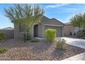 Charming single-story home featuring a well-manicured front yard with desert landscaping and a two-car garage at 4595 W Stonecrop Dr, San Tan Valley, AZ 85144